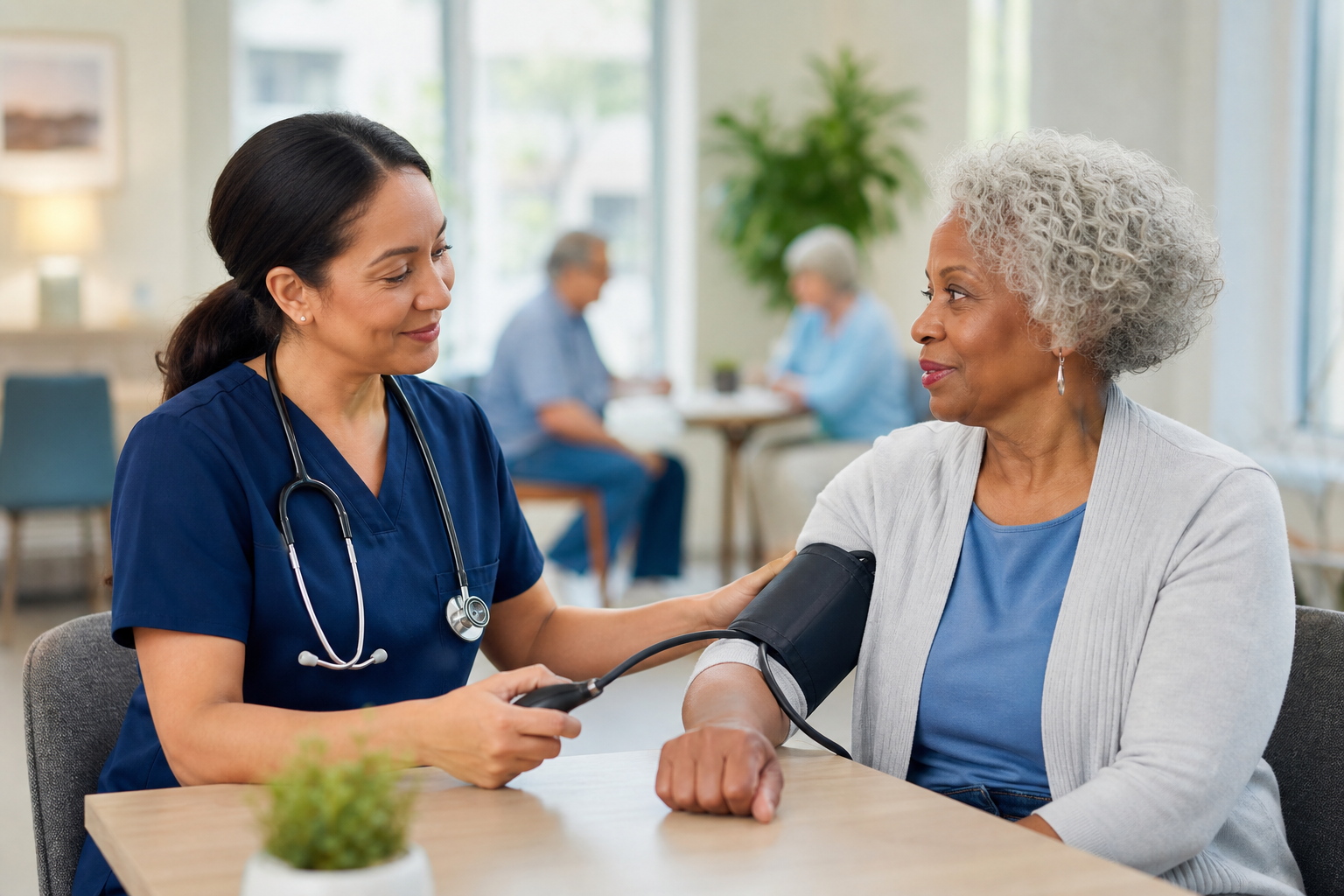 A nurse checking an older woman&rsquo;s blood pressure
